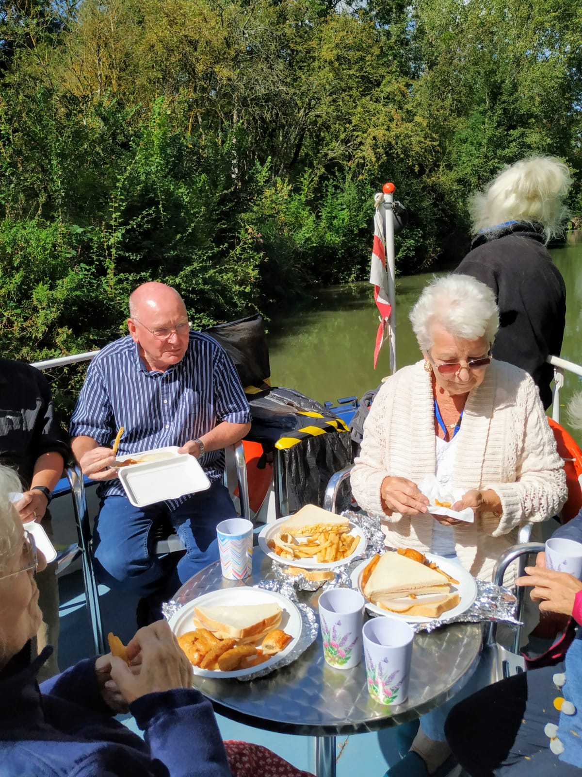 Service users having lunch on their boat trip day out