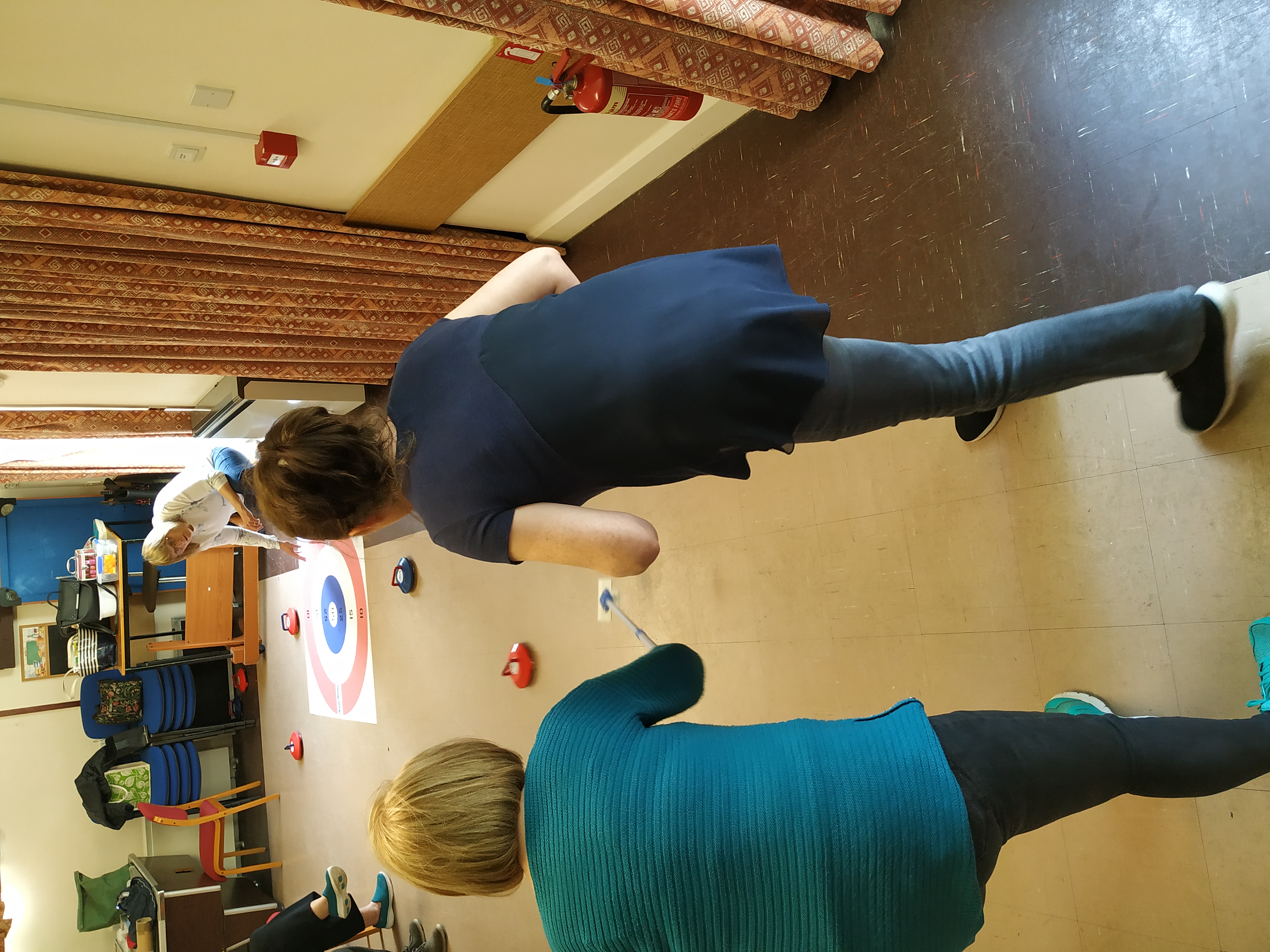Service users having a fun game of Kurling